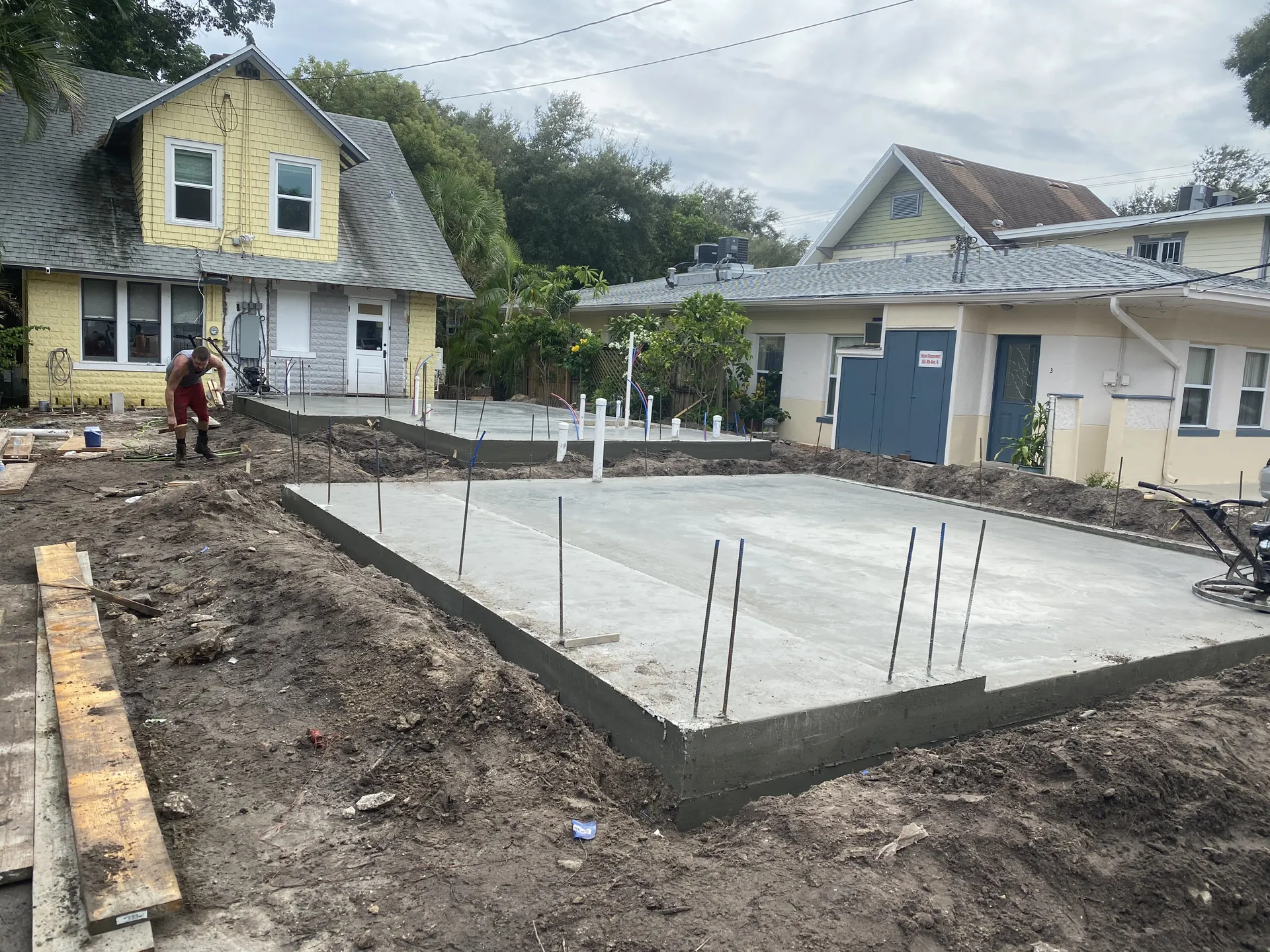 Freshly poured concrete foundation slab with rebar for new construction