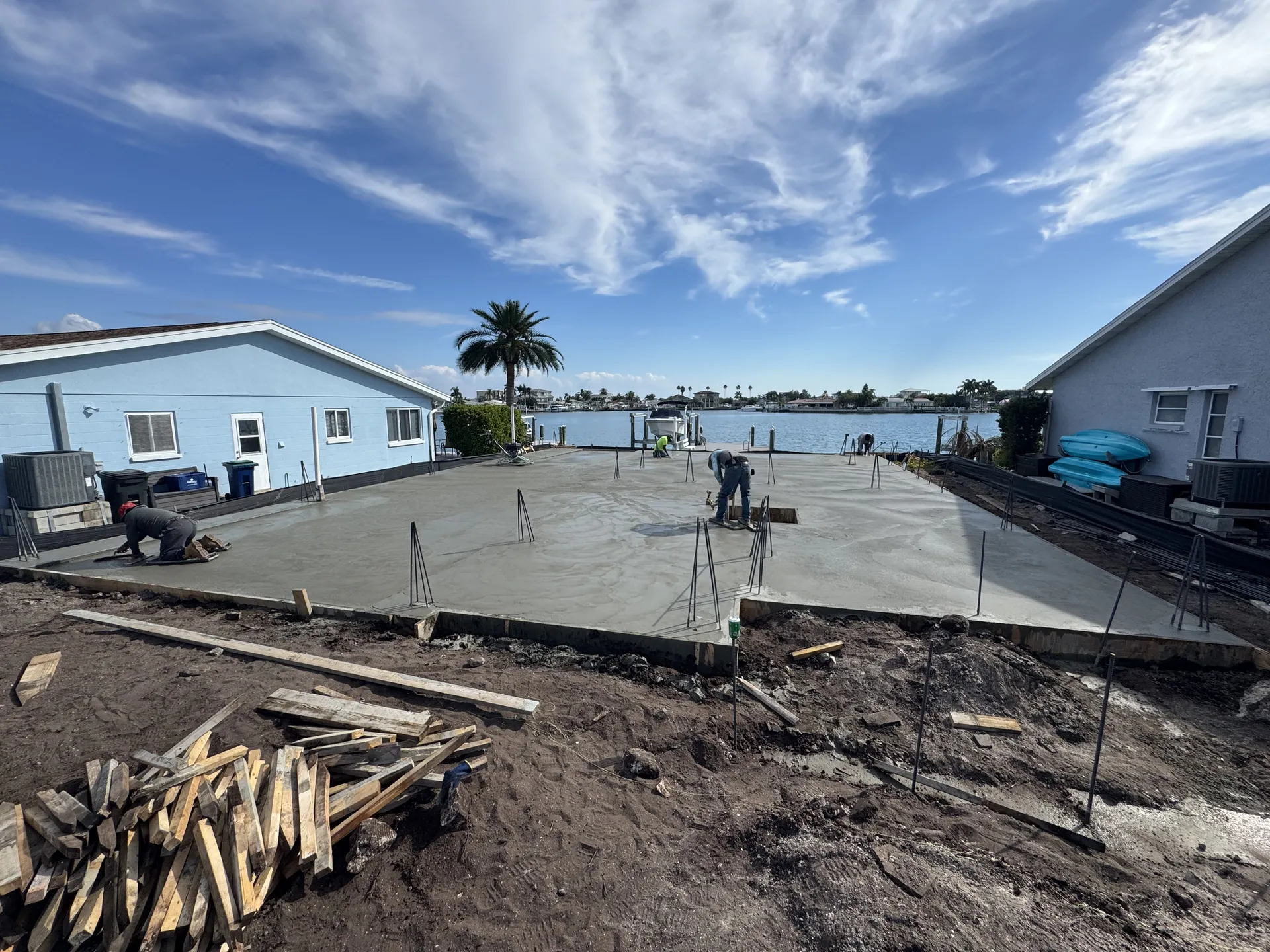 Concrete foundation slab being finished at a waterfront property