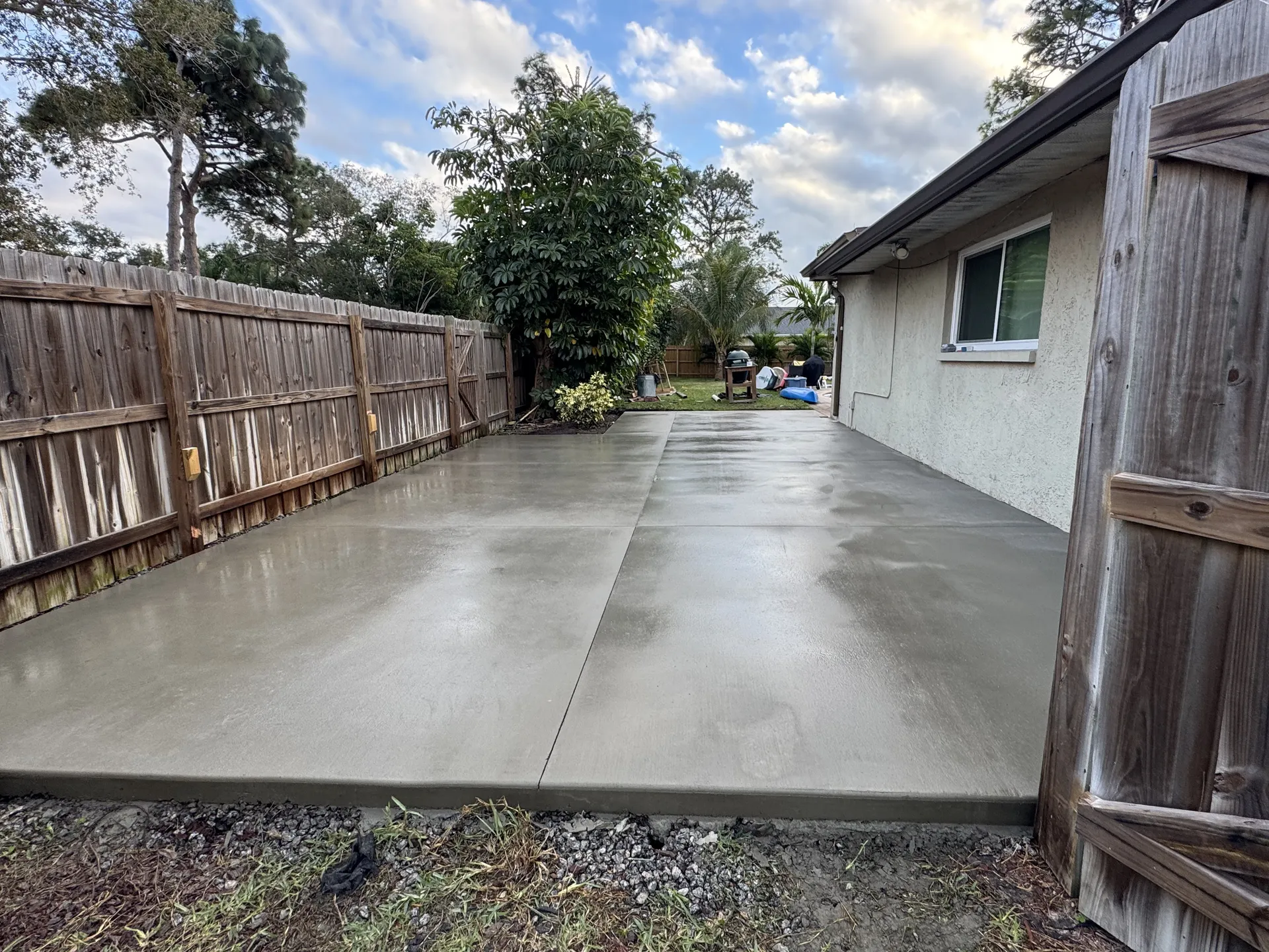 Finished concrete patio slab along the side of a residential home