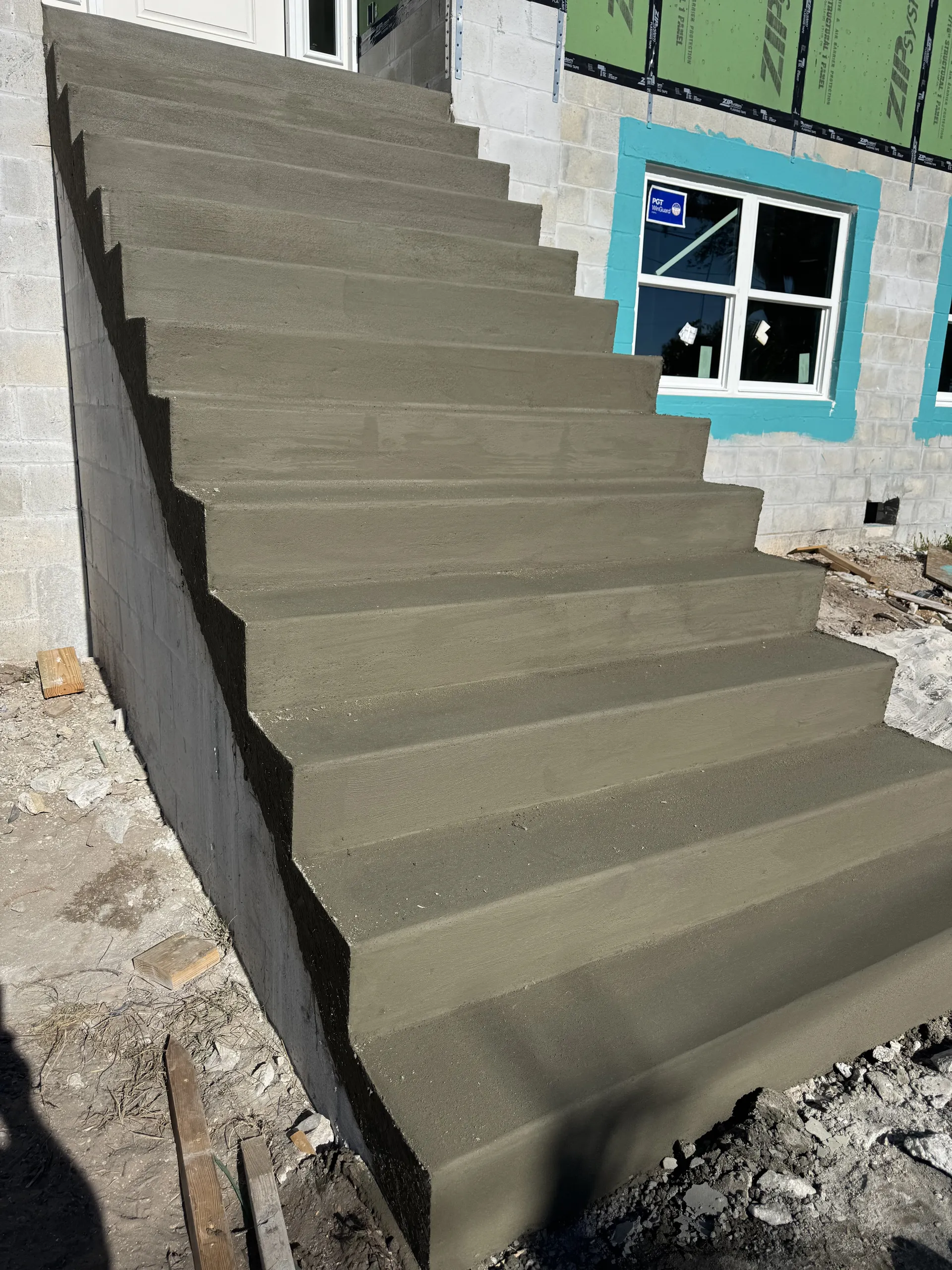 Freshly poured concrete exterior staircase at a new construction home