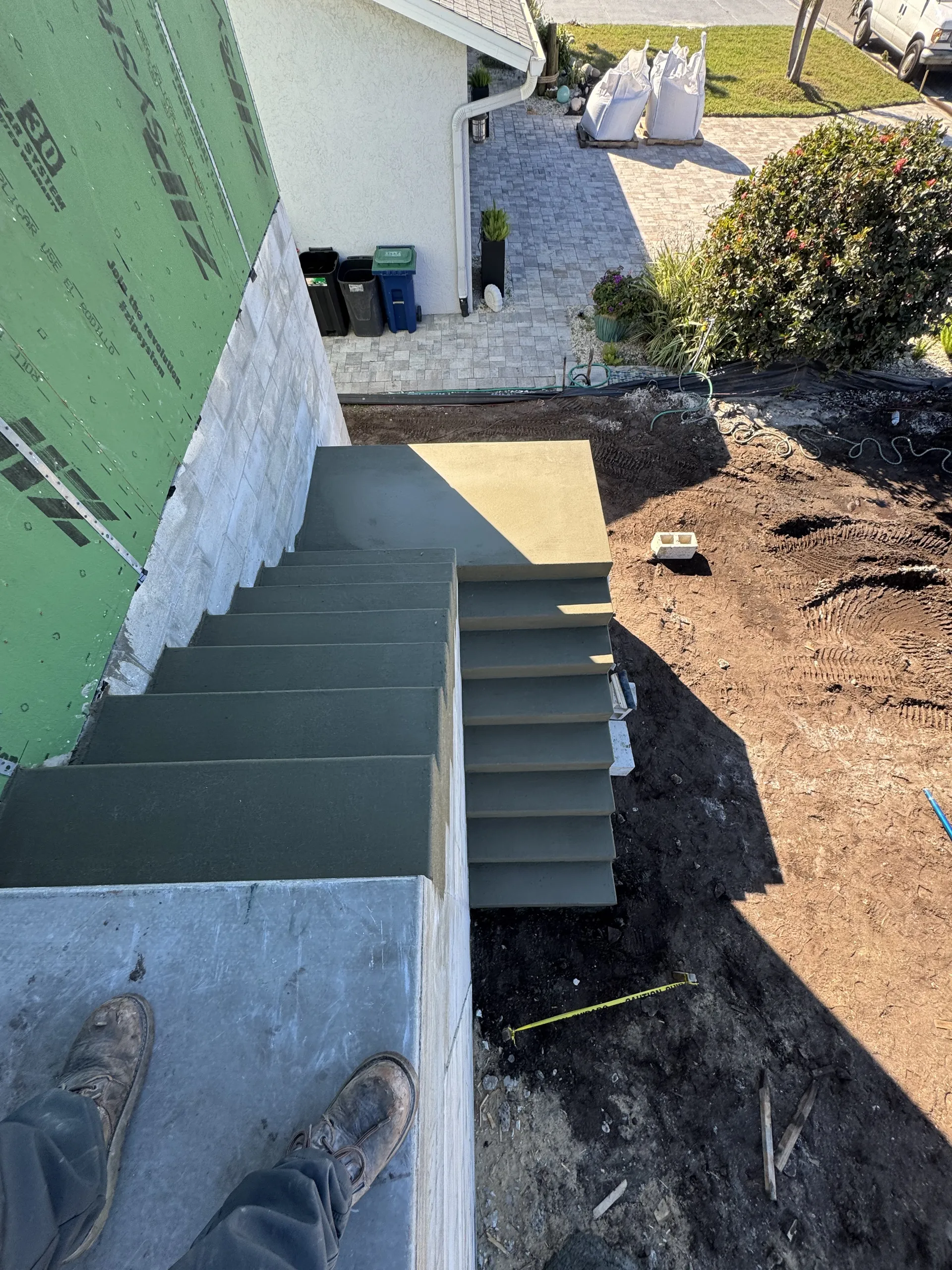 Completed concrete exterior staircase with landing viewed from above