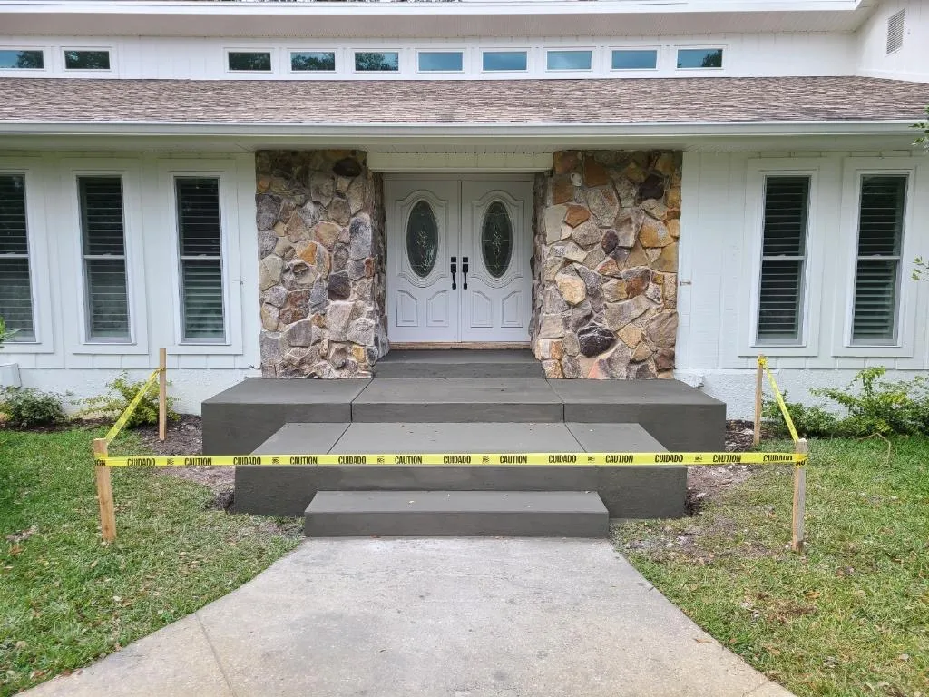 New concrete front porch steps with stone accent columns